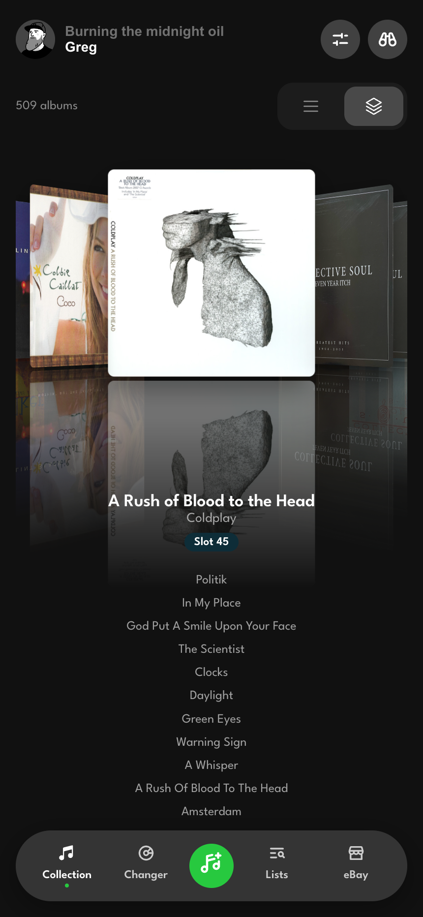 The cover-flow wall with one album centered and its neighbors fanning out behind it